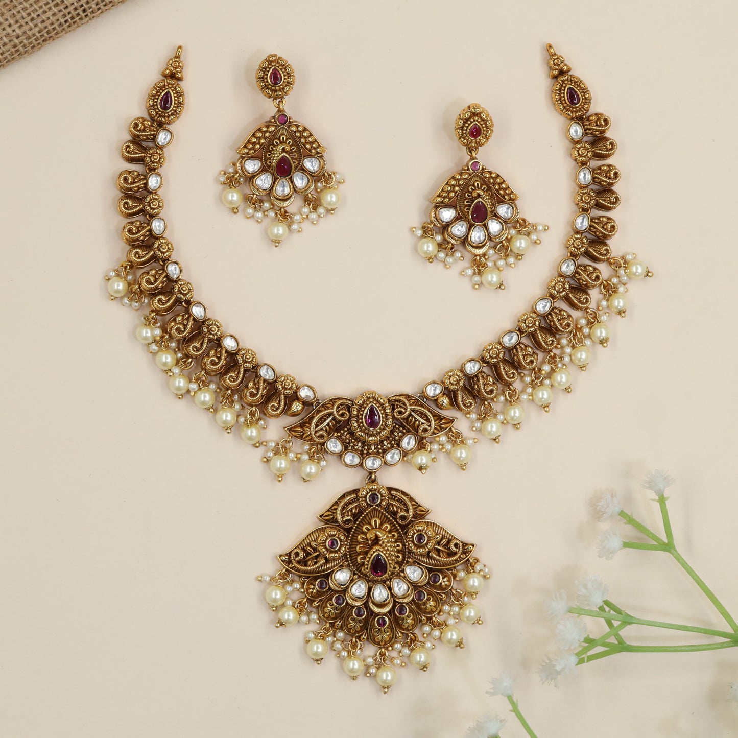Designer temple necklace with decorative scroll links and ornate centrepiece