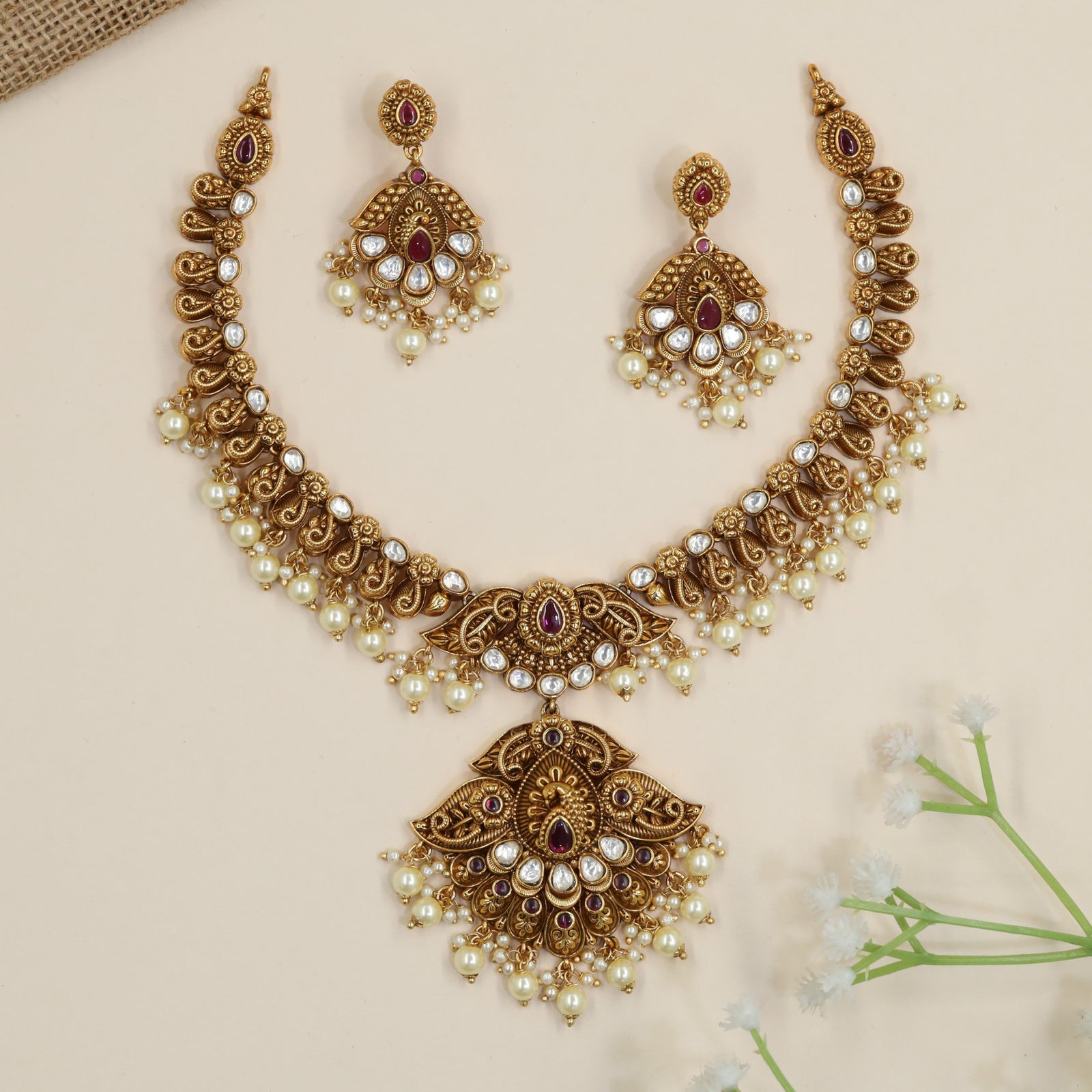 Designer temple necklace with decorative scroll links and ornate centrepiece