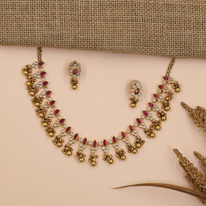 Teardrop Antique Necklace Featuring Floral Stone Arrangement and Dangling Bead Charms