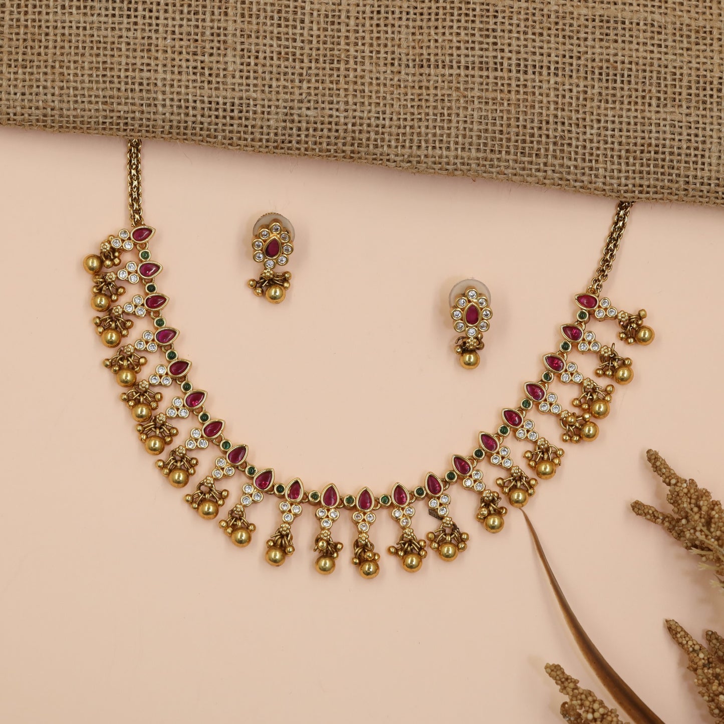 Teardrop Antique Necklace Featuring Floral Stone Arrangement and Dangling Bead Charms
