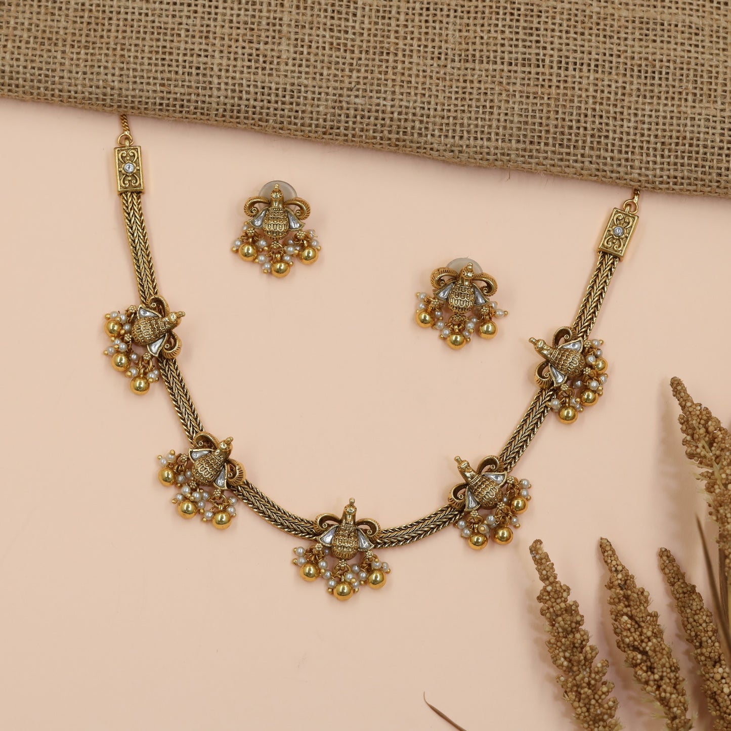 Braided Antique Necklace Featuring Decorative Jhumka Charms and Floral Accents