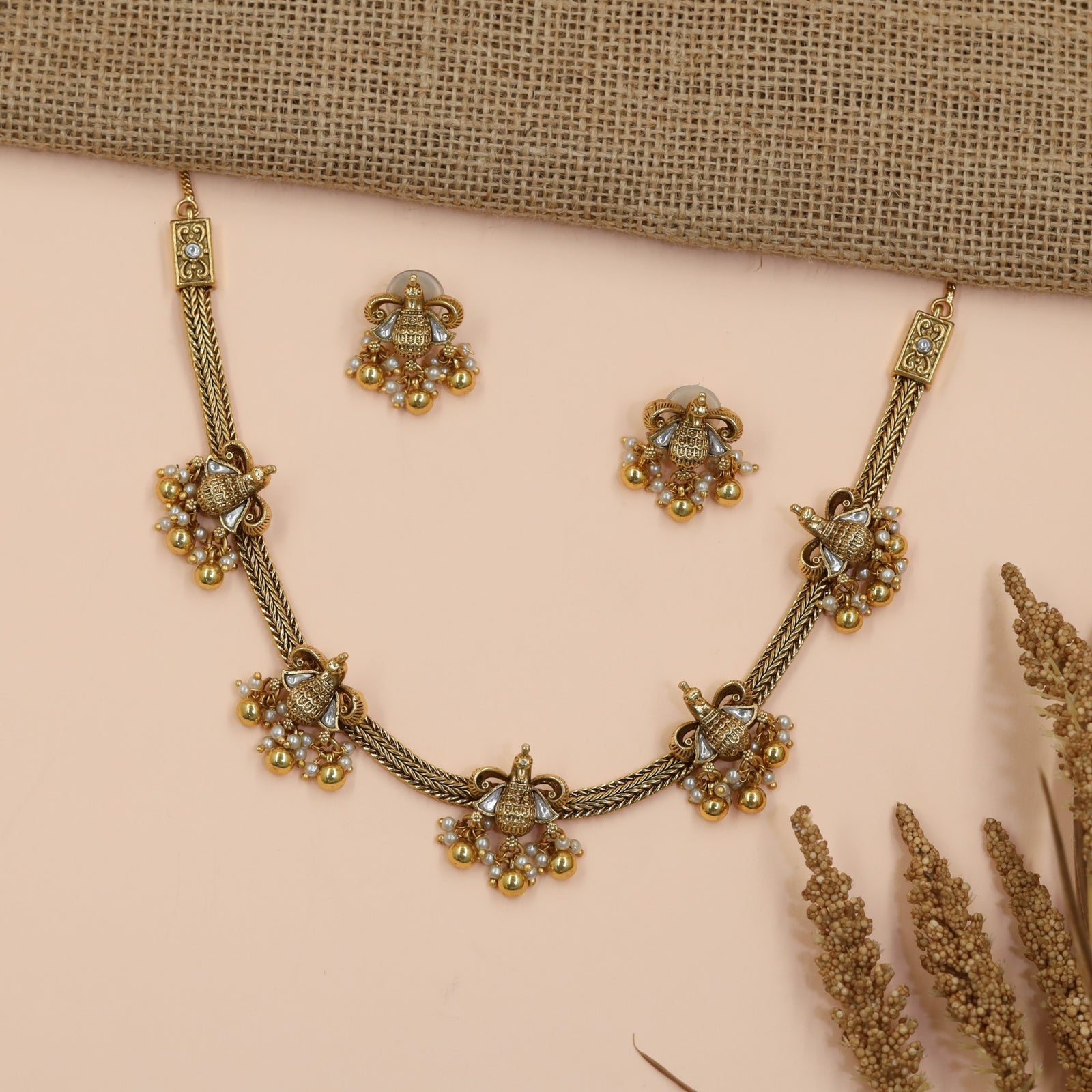 Braided Antique Necklace Featuring Decorative Jhumka Charms and Floral Accents
