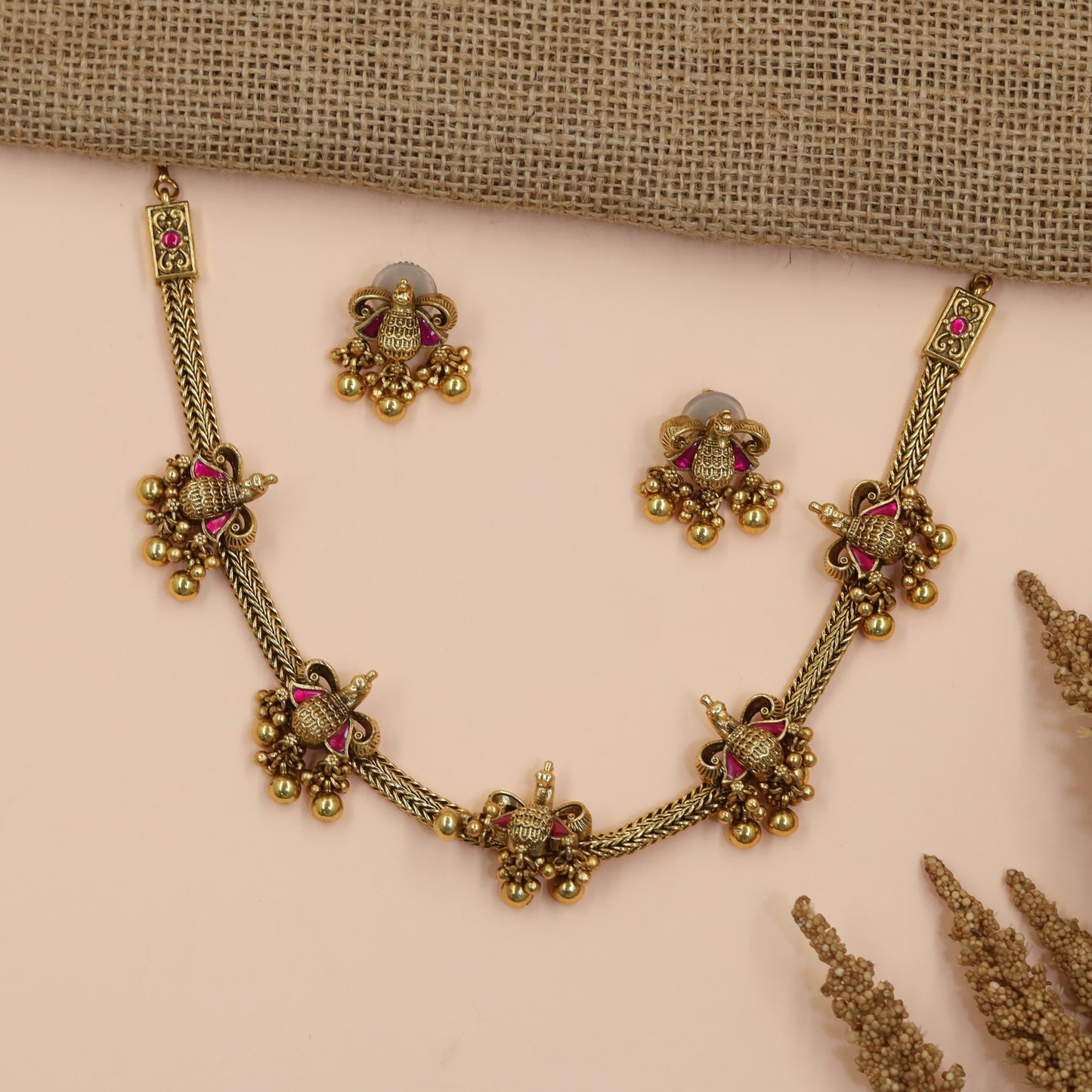 Braided Antique Necklace Featuring Decorative Jhumka Charms and Floral Accents