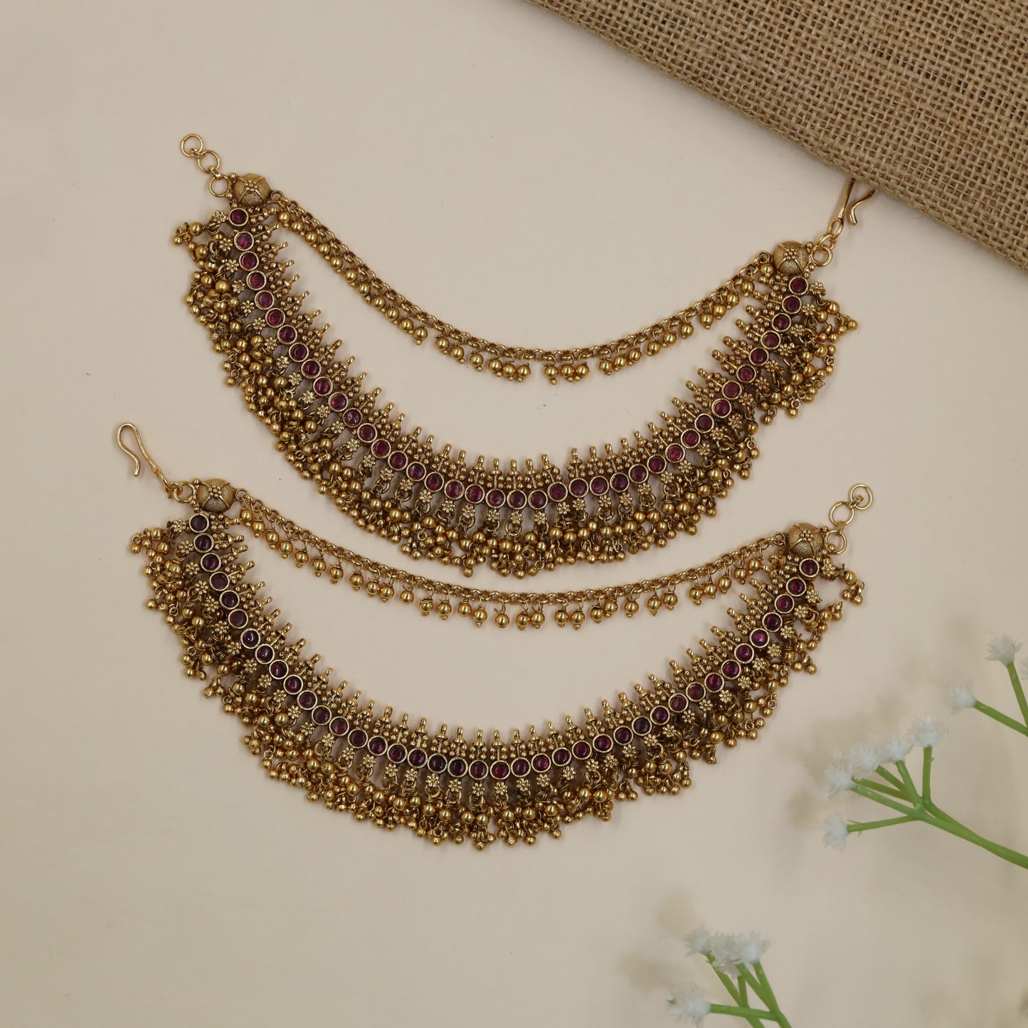 Antique Mati Featuring Intricate Round Accents and Hanging Beads