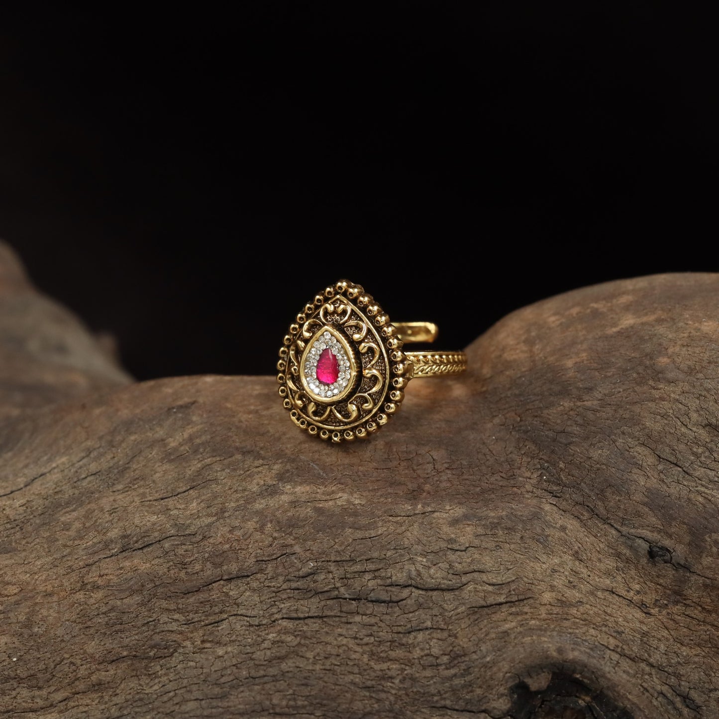 Antique Finger Ring Showcasing Intricate Floral Curves and Detailed Teardrop Framing
