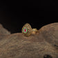 Antique Finger Ring Showcasing Intricate Floral Curves and Detailed Teardrop Framing