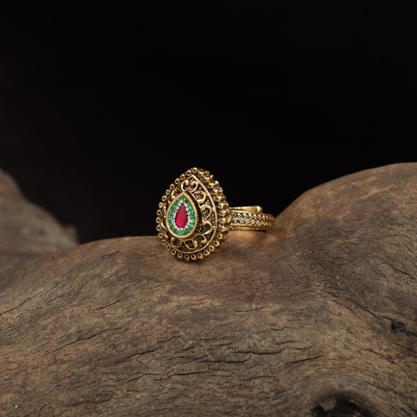 Antique Finger Ring Showcasing Intricate Floral Curves and Detailed Teardrop Framing