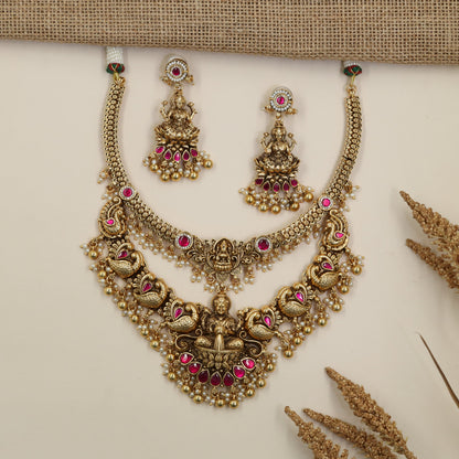 Antique Necklace with Detailed Lakshmi Pendant and Repeating Peacock Motifs