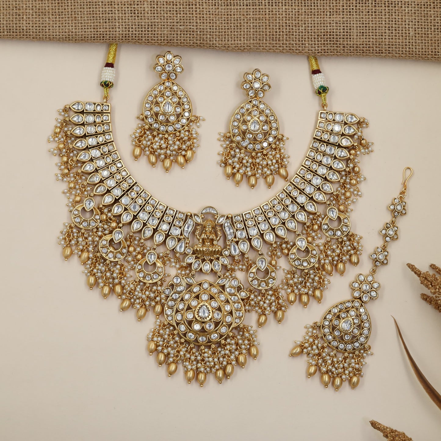 Classic royal Jadau collar necklace featuring crescent moon drops and pearl clusters