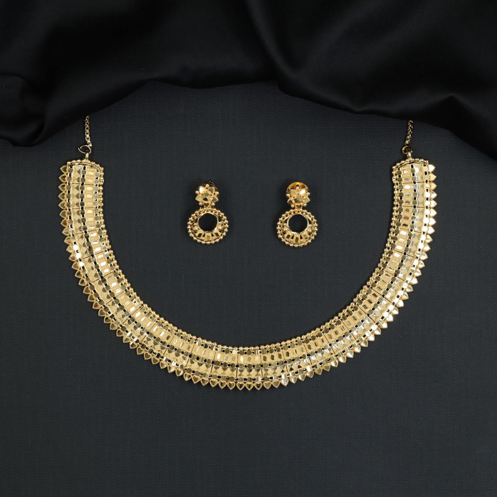 Forming Necklace with Broad Panel Work and Scalloped Edge Detailing