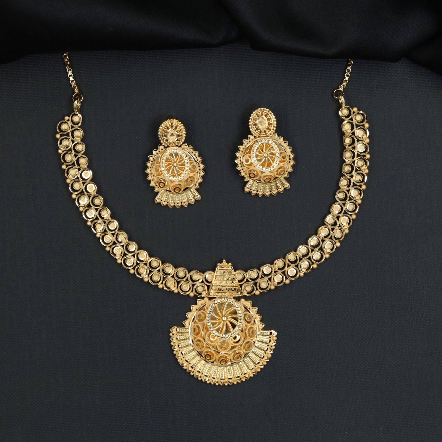 Concentric openwork discs with a sculpted fringe pendant in a Forming Necklace