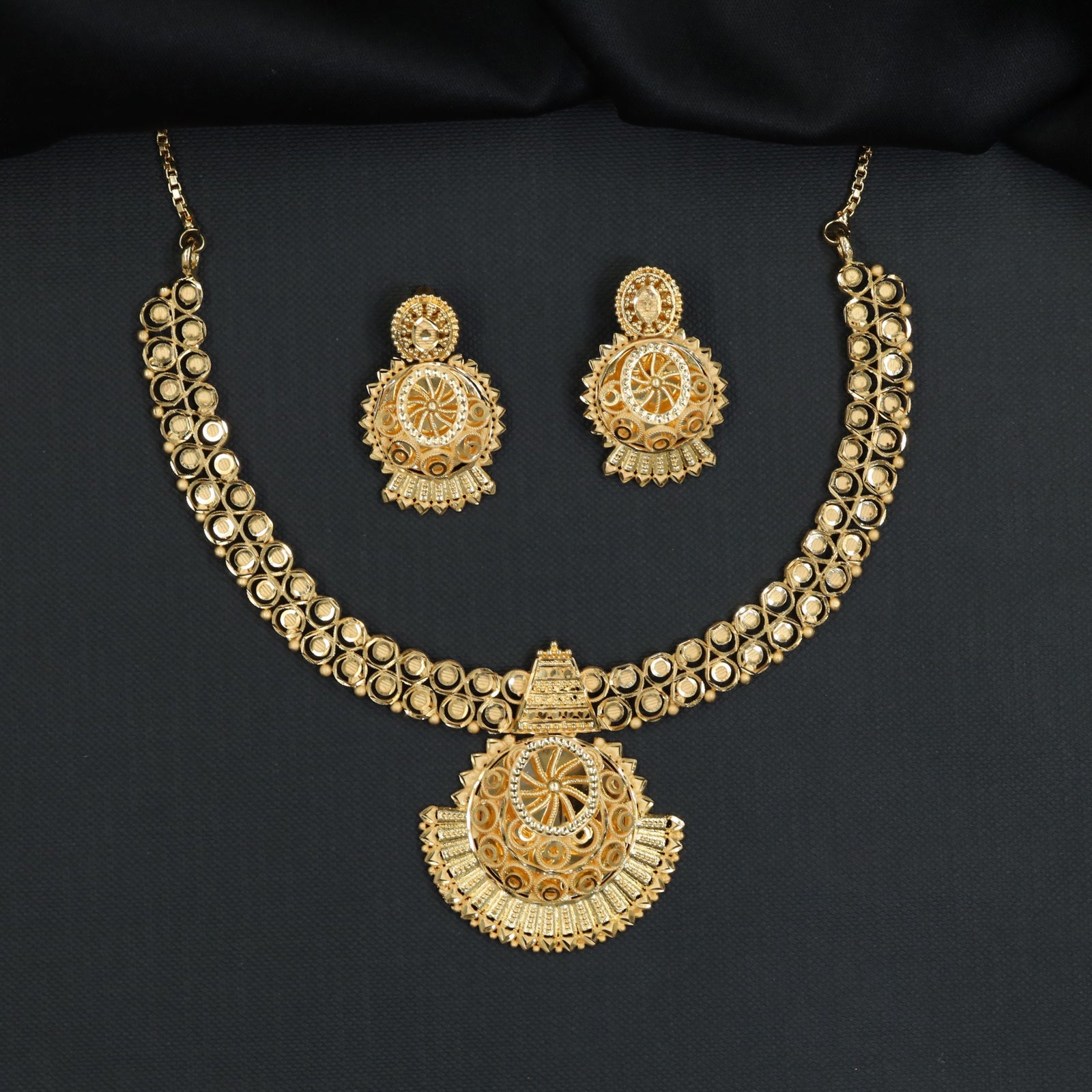 Concentric openwork discs with a sculpted fringe pendant in a Forming Necklace