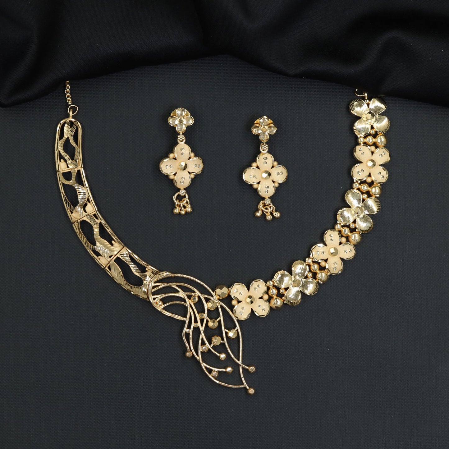 Asymmetric Forming Necklace with floral clover strand and sweeping leaf tendril