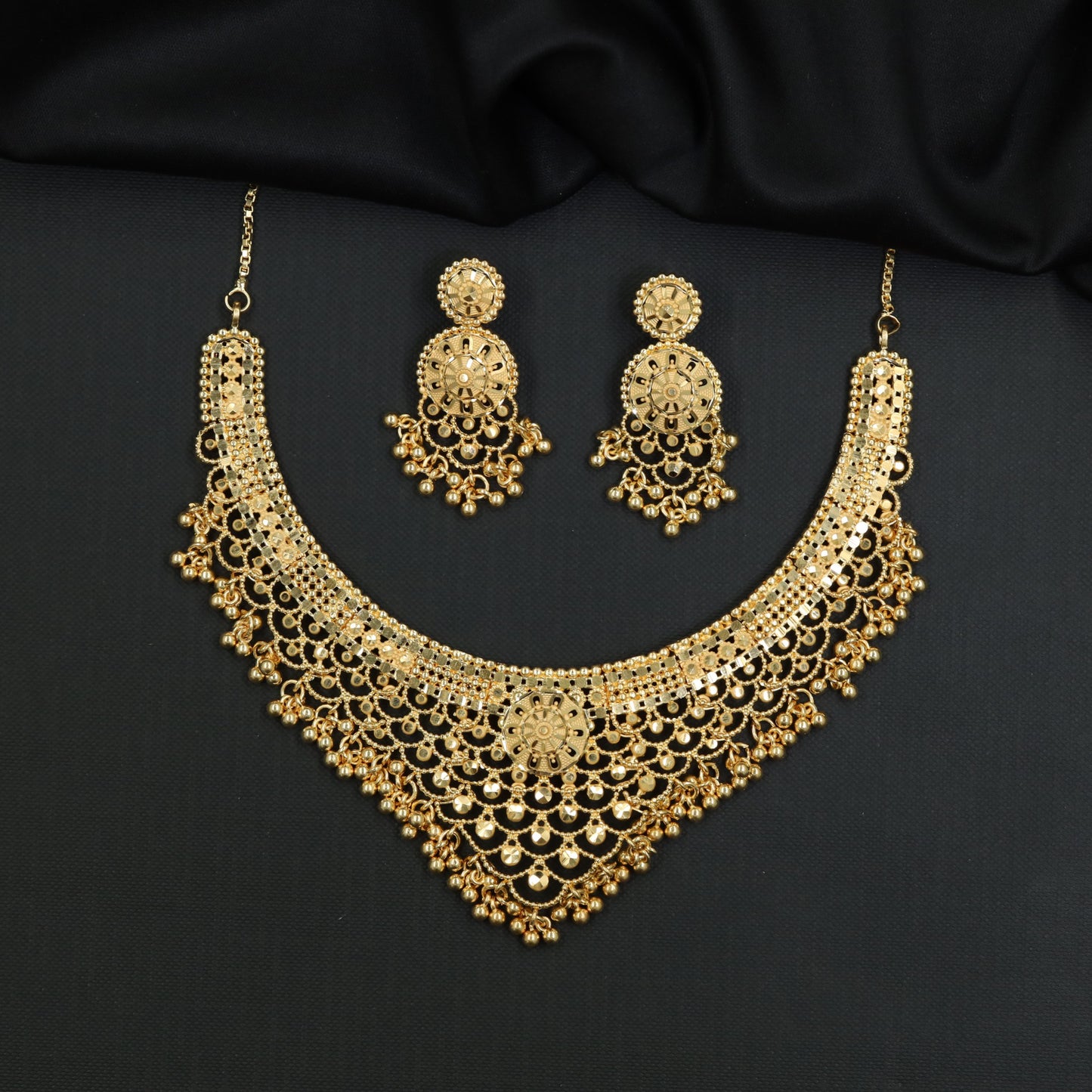 Openwork multi-row Forming Necklace with suspended ball tassel accents
