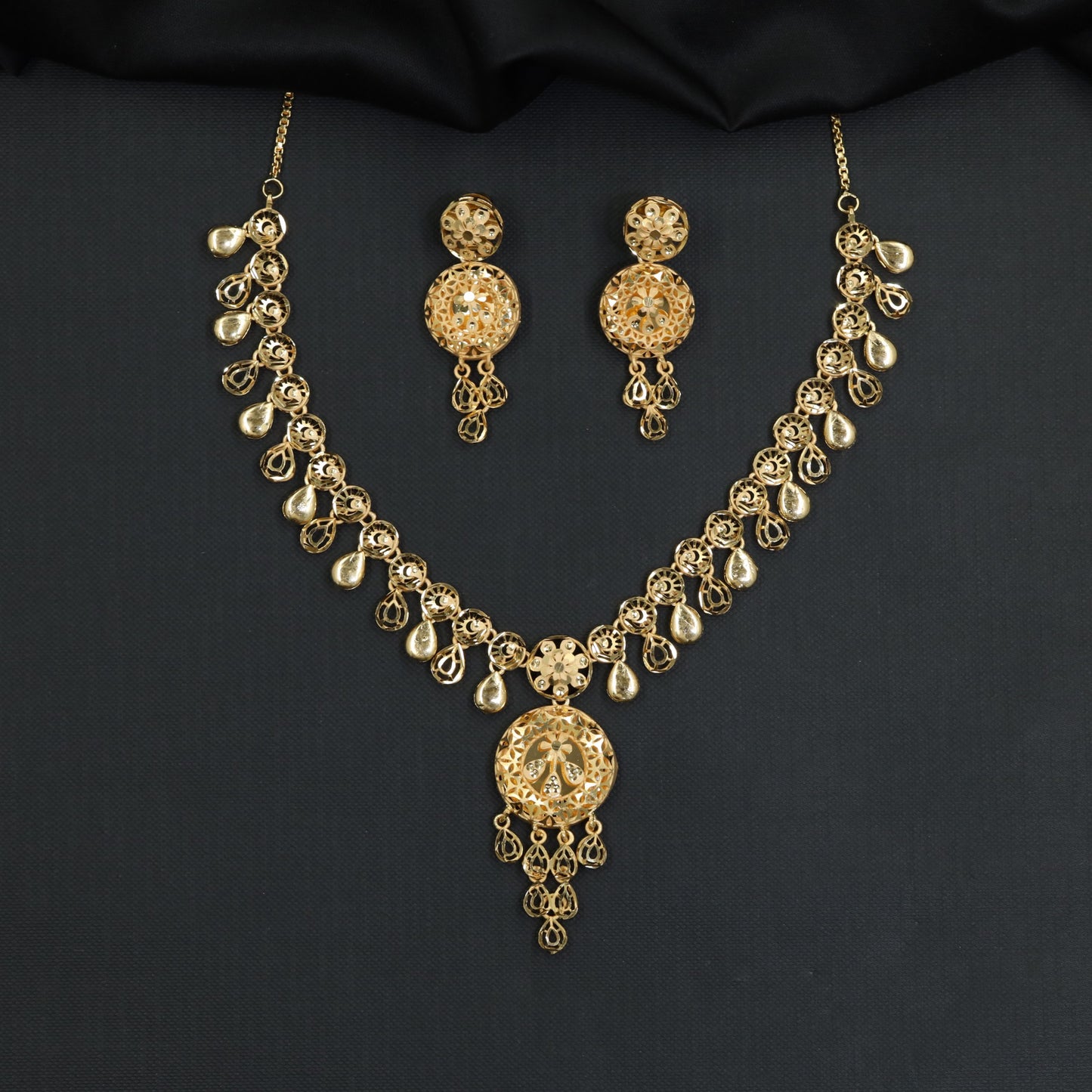 Forming Necklace with dangling teardrop charms and medallion locket