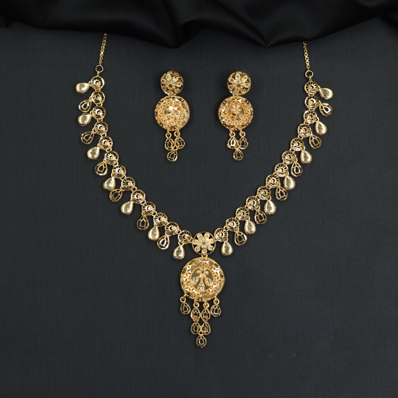 Forming Necklace with dangling teardrop charms and medallion locket