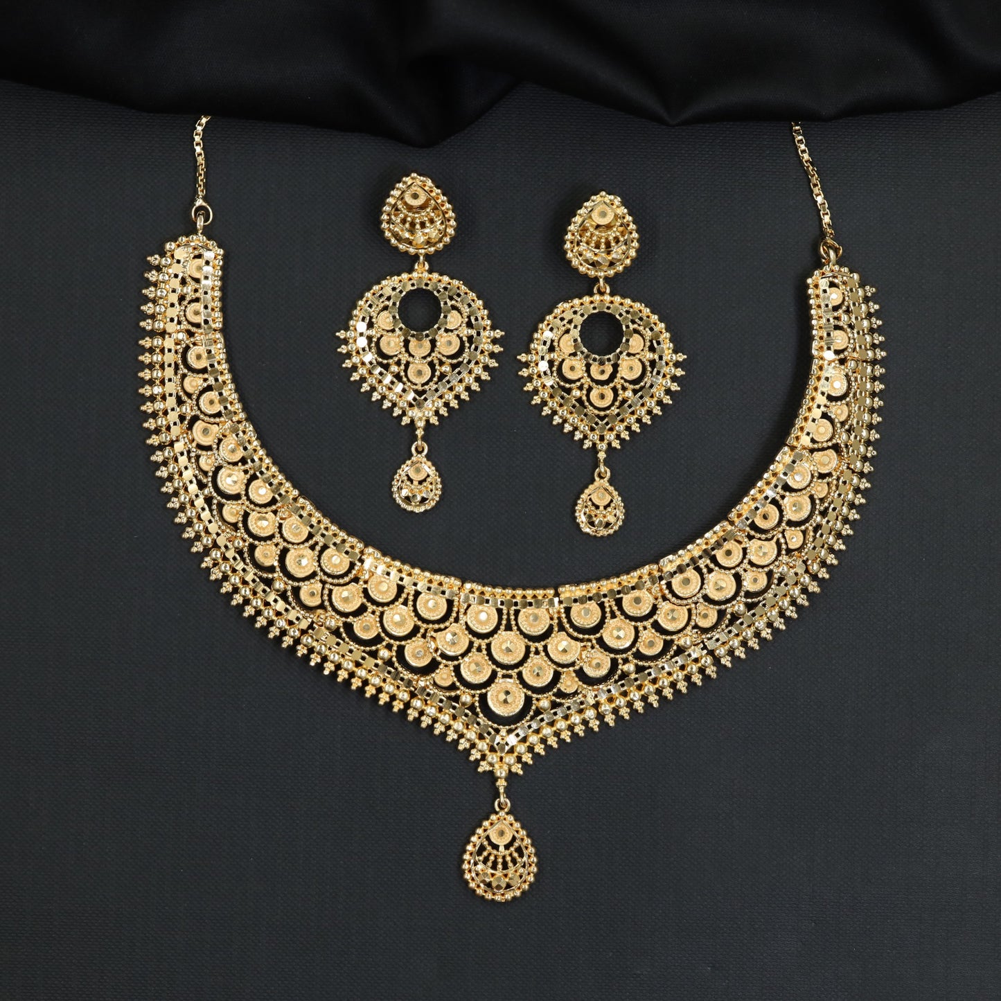 Royal celebration Forming Necklace featuring textured circular metalwork