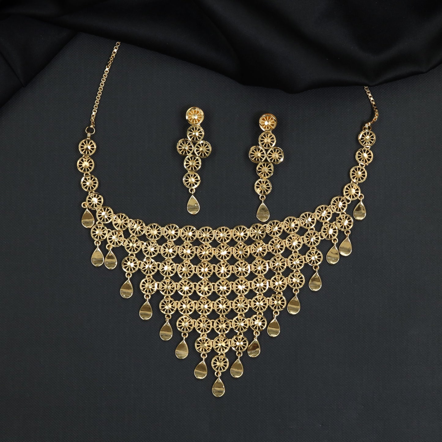 Forming Necklace with cascading wheel cutout bib and smooth drops