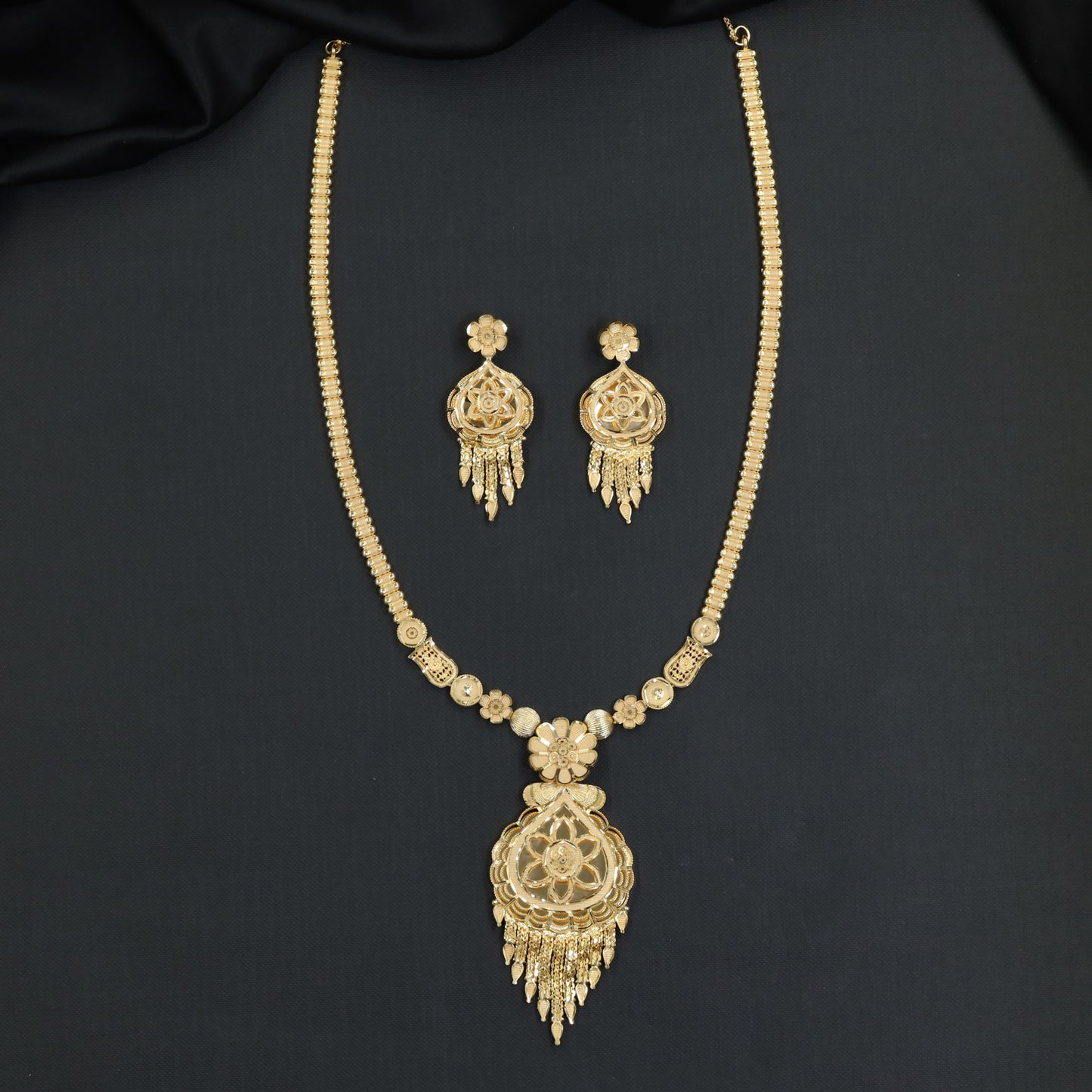 Forming Long Haara with floral filigree medallion and tassel drops