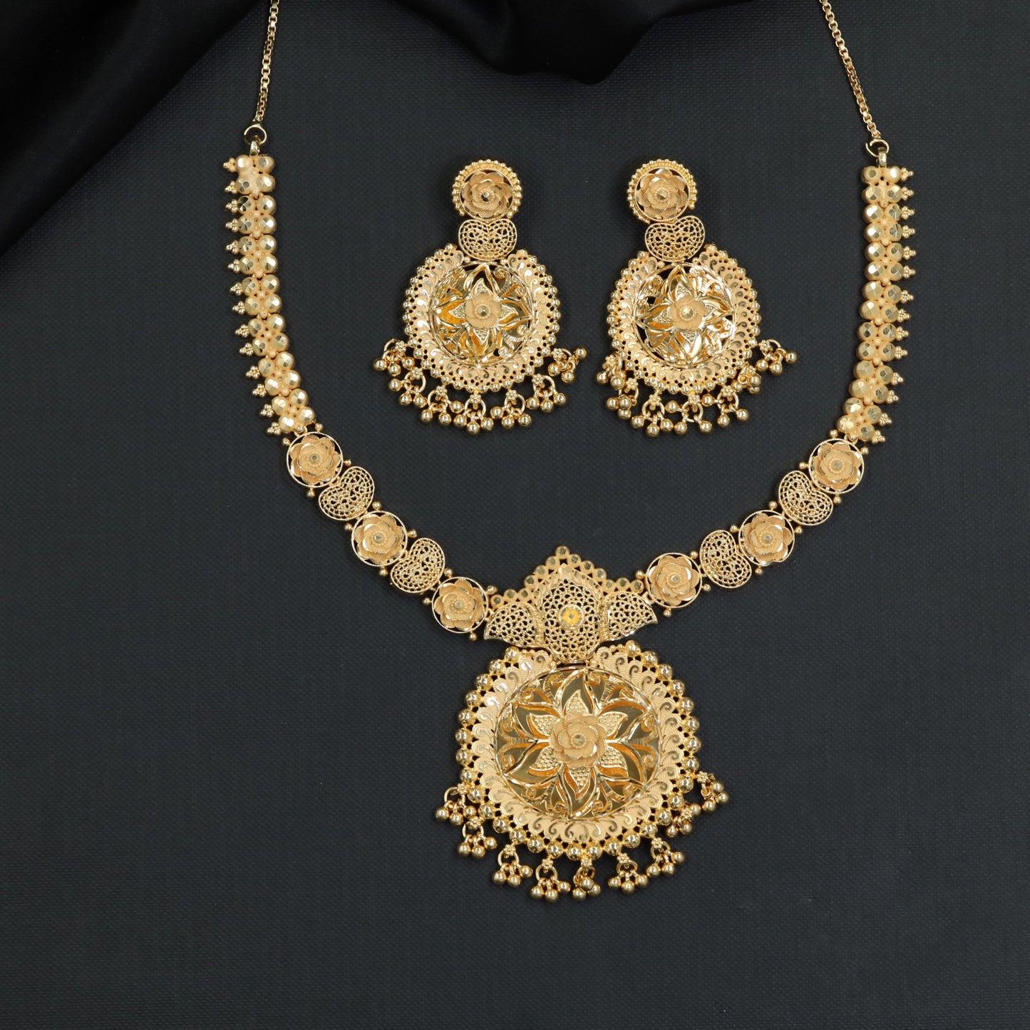 Radiant floral discs arranged along an ornate Forming Necklace