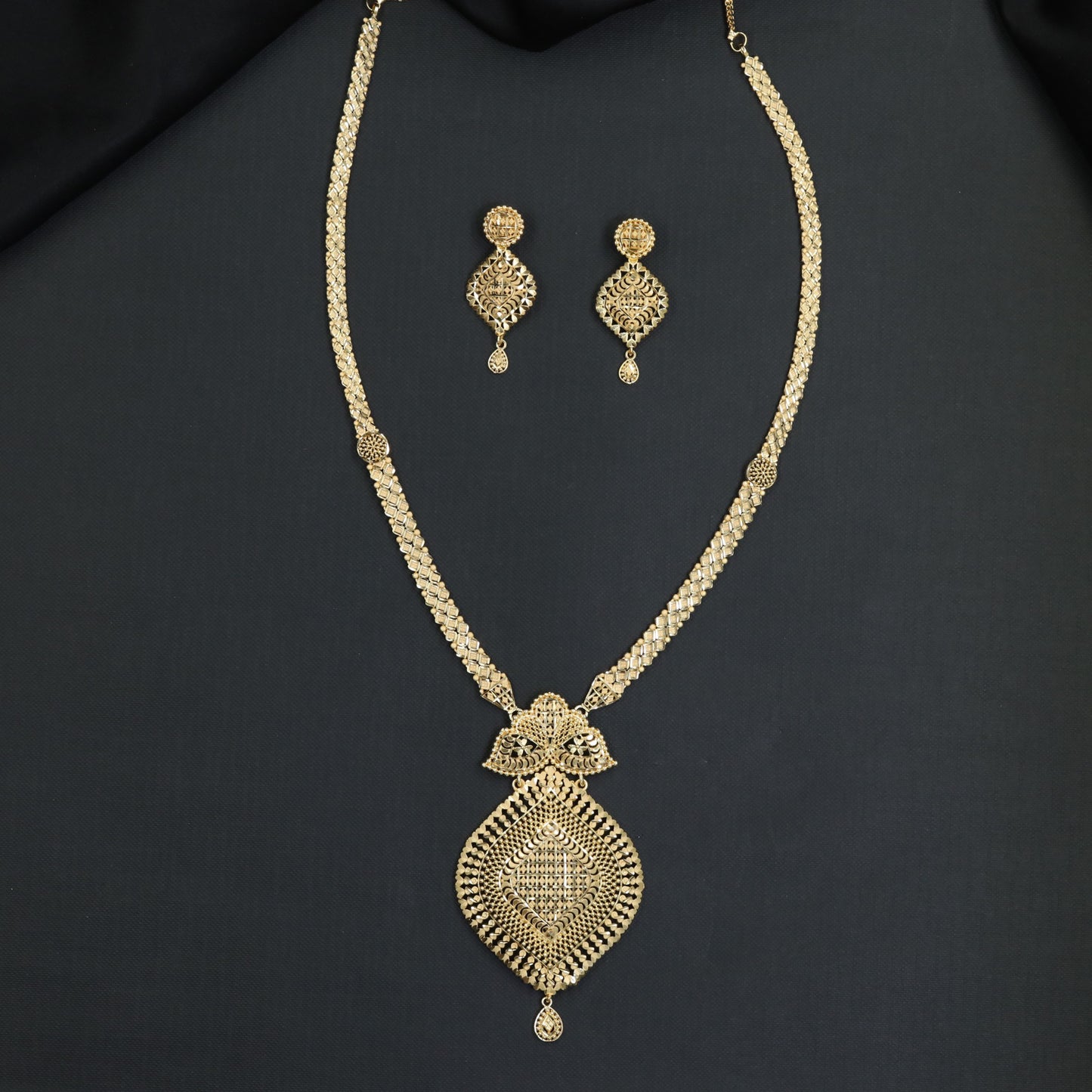 Refined filigree craftsmanship defines this statement Forming Long Haara