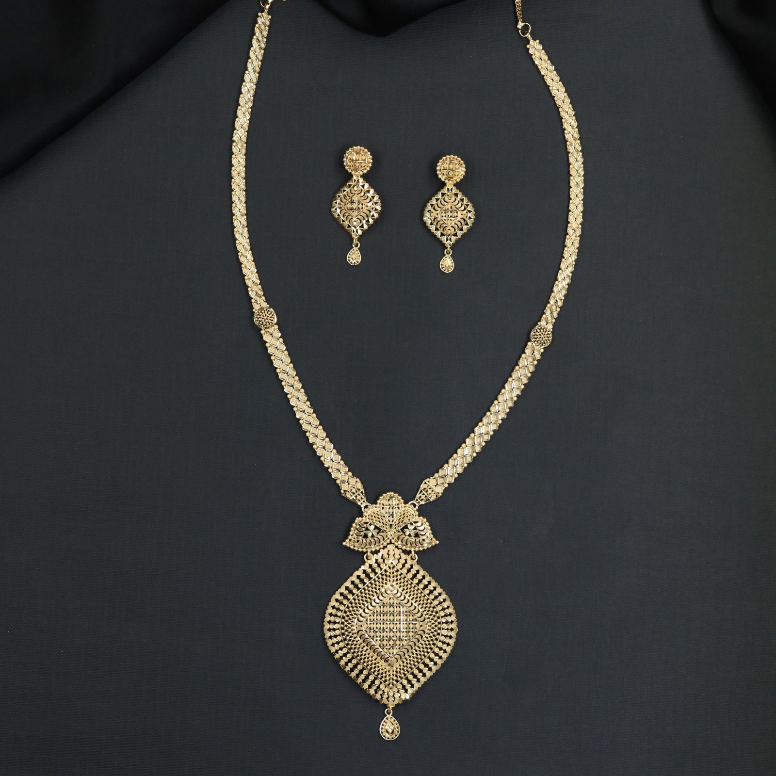 Refined filigree craftsmanship defines this statement Forming Long Haara