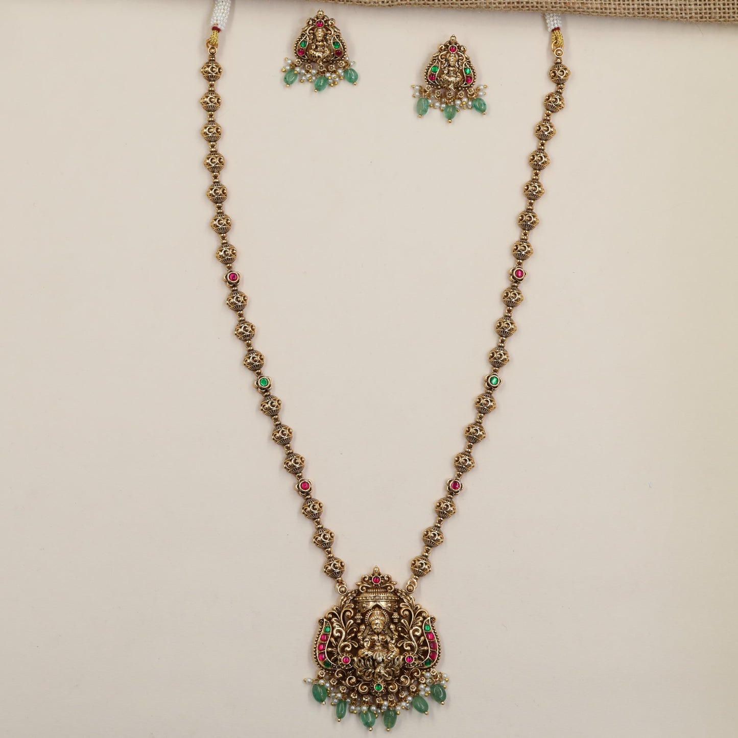 Antique Chain Showcasing a Grand Lakshmi Pendant and Decorative Round Links