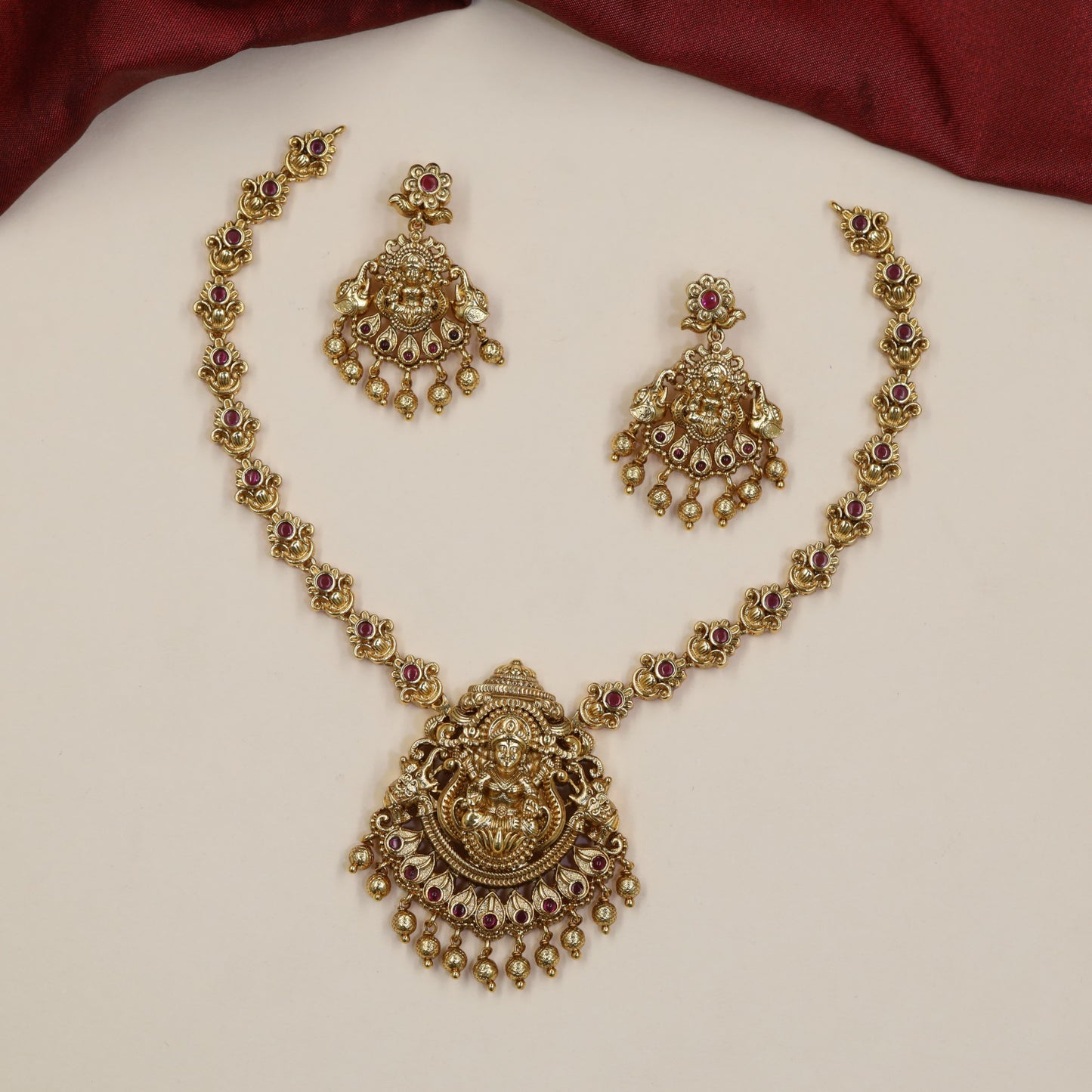 Regal Lakshmi Necklace Featuring Repeated Floral Forms and Ornamental Centre Detailing