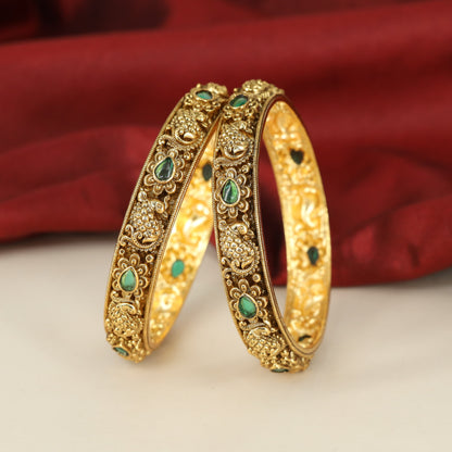 Traditional Peacock Motif Bangles with Repeated Floral Settings and Sculpted Detailing