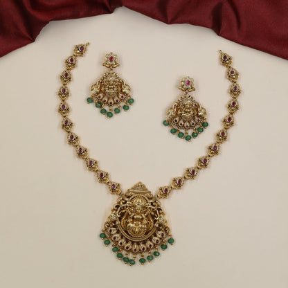 Regal Lakshmi Necklace Featuring Repeated Floral Forms and Ornamental Centre Detailing