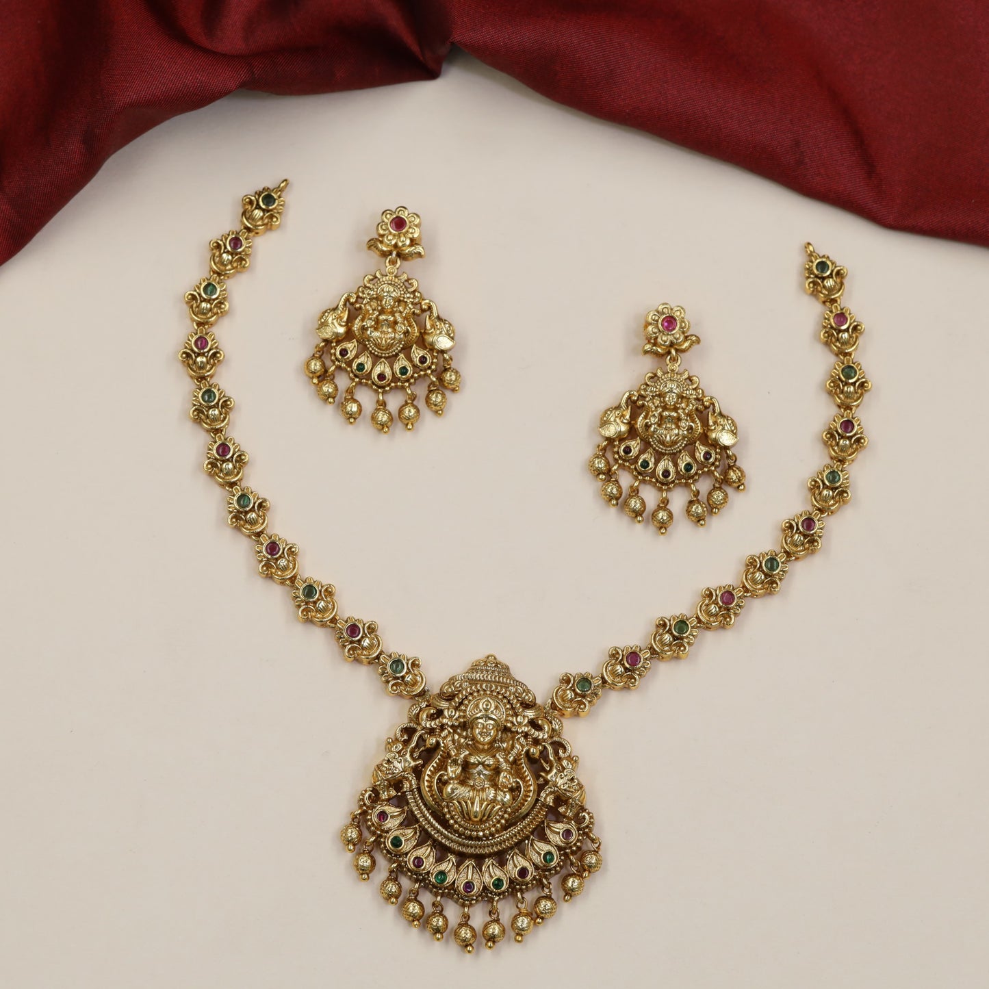 Regal Lakshmi Necklace Featuring Repeated Floral Forms and Ornamental Centre Detailing