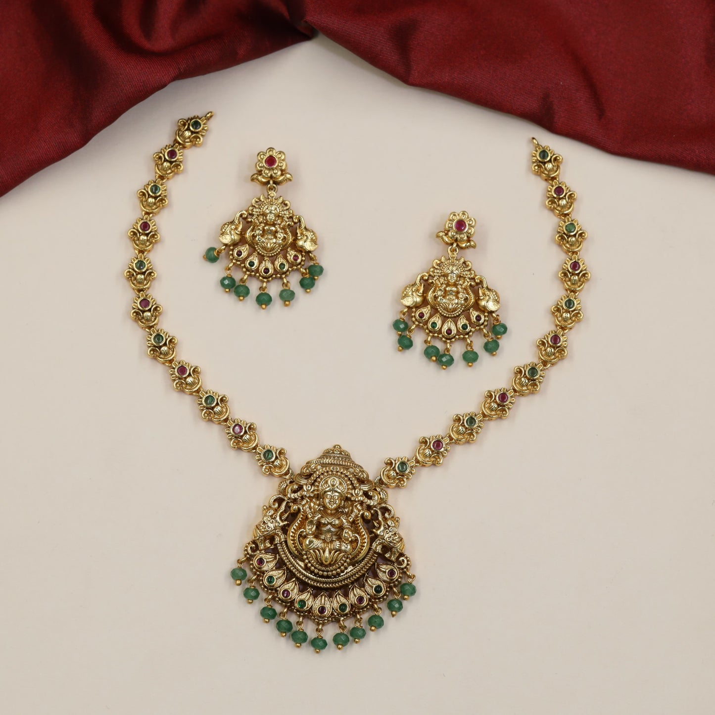 Regal Lakshmi Necklace Featuring Repeated Floral Forms and Ornamental Centre Detailing