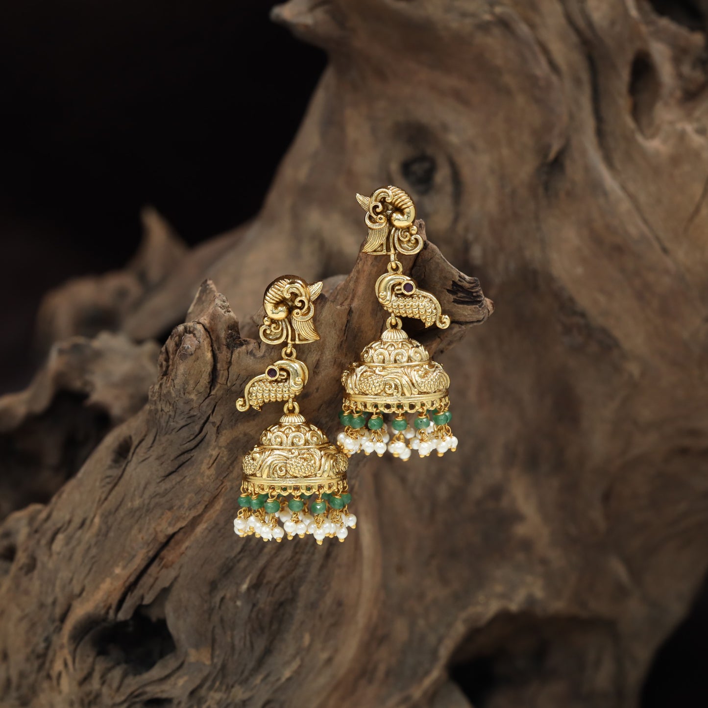 Temple-inspired Antique Jumka featuring peacock forms and engraved dome work