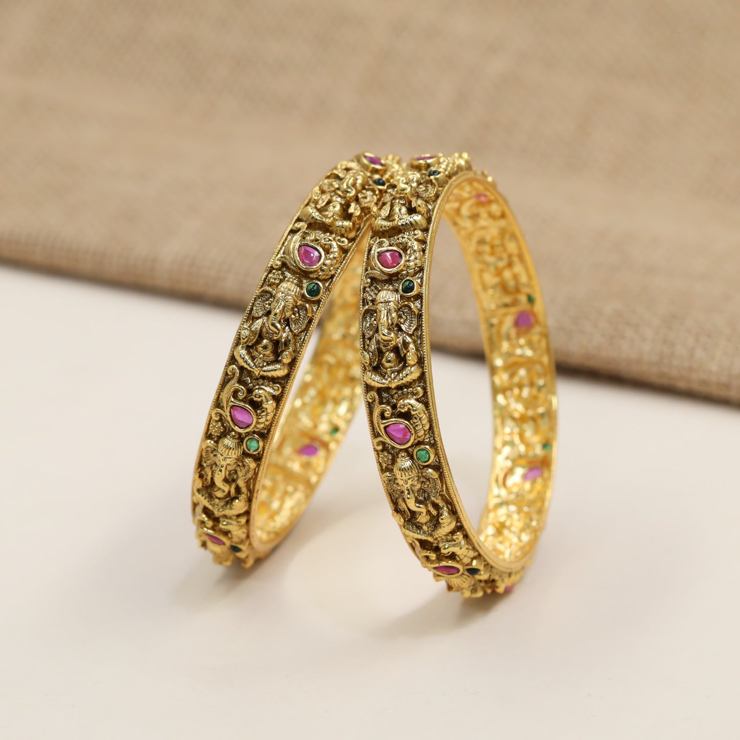 Crafted Ganesha Antique Bangles with sculpted figures and ornamental framing