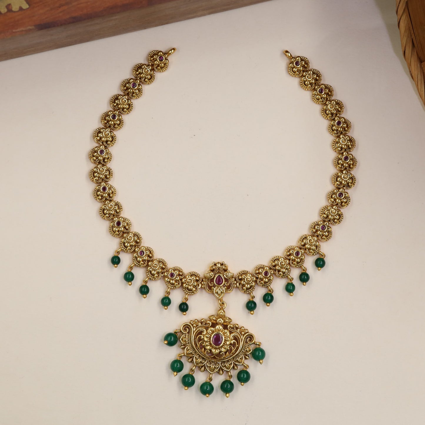 Classical Necklace Featuring Repeating Floral Sections And Hanging Elements
