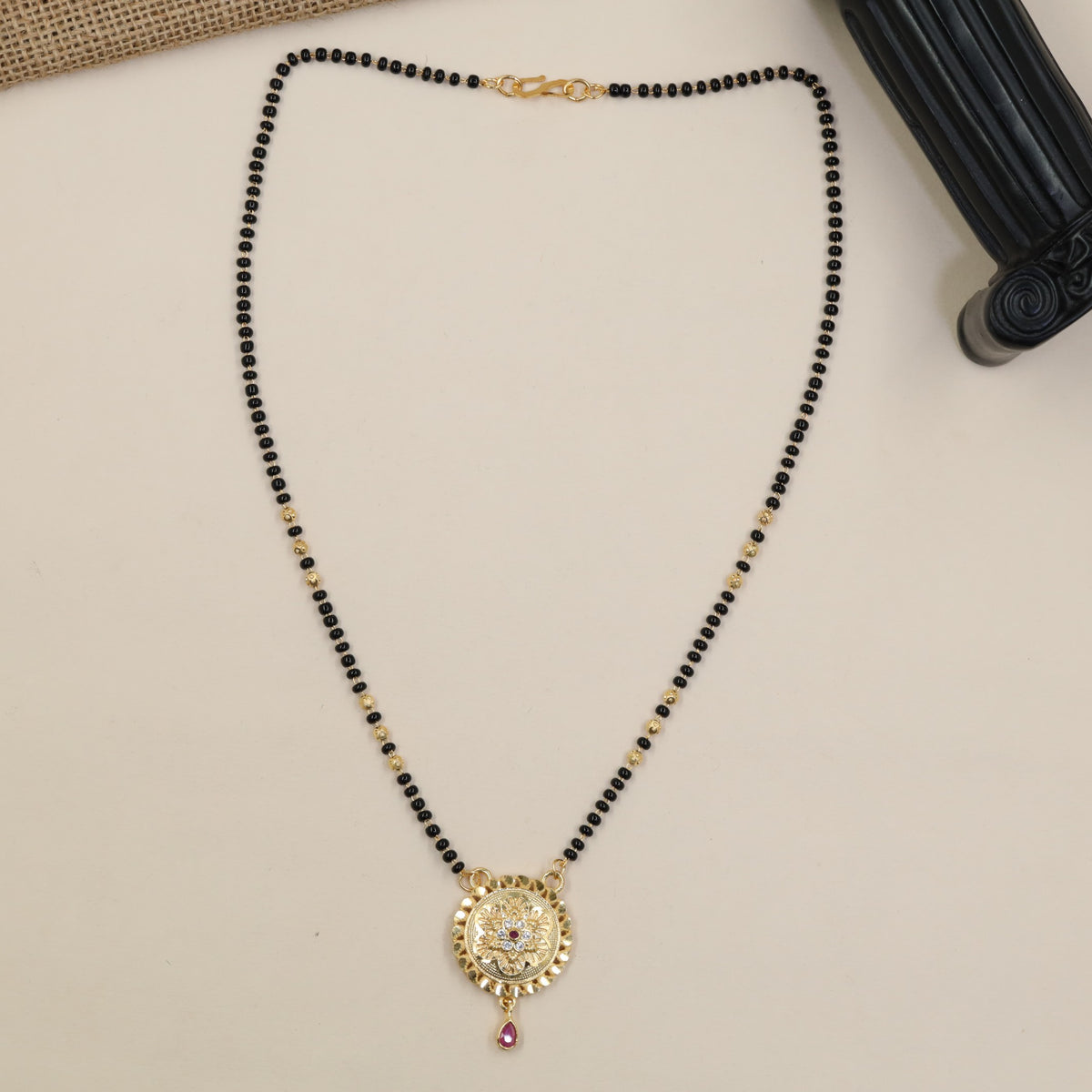 A Refined Gold Plated Mangalsutra With Detailed Centre Pendant And Fine Beaded Chain