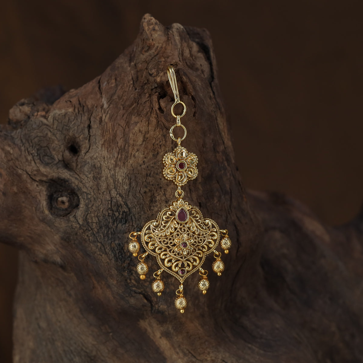 Antique Tikka with an intricate floral crest and ornate scrollwork pendant