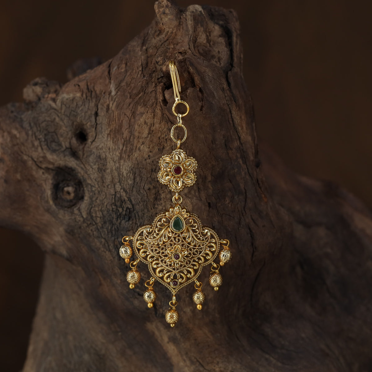 Antique Tikka with an intricate floral crest and ornate scrollwork pendant