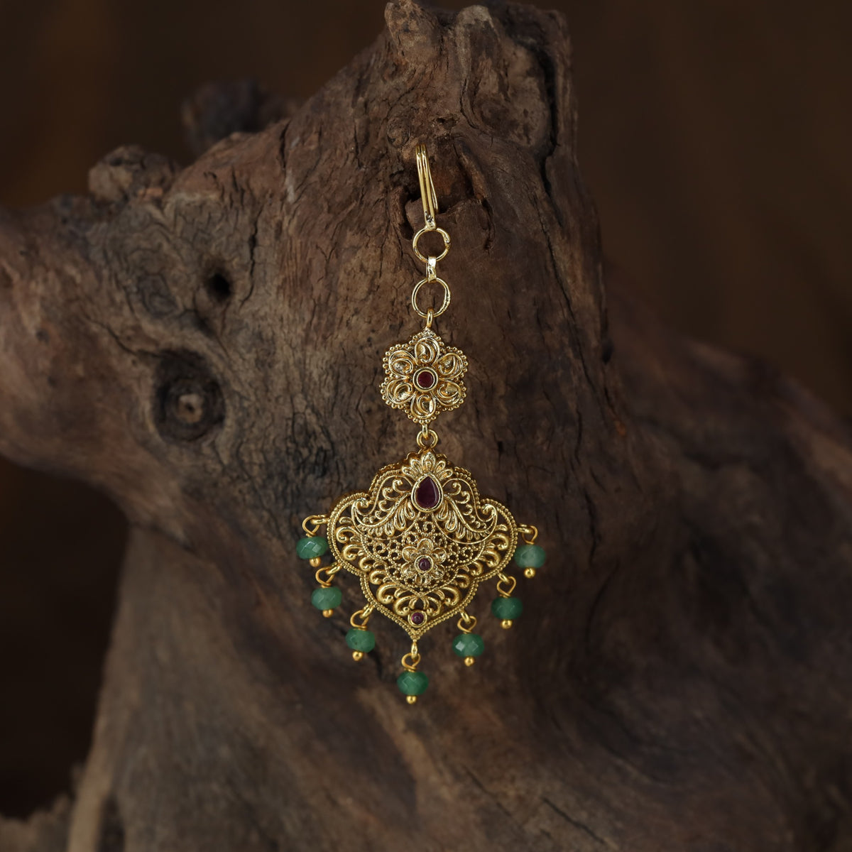 Antique Tikka with an intricate floral crest and ornate scrollwork pendant