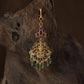 Antique Tikka showcasing a seated Lakshmi framed by graceful peacock figures