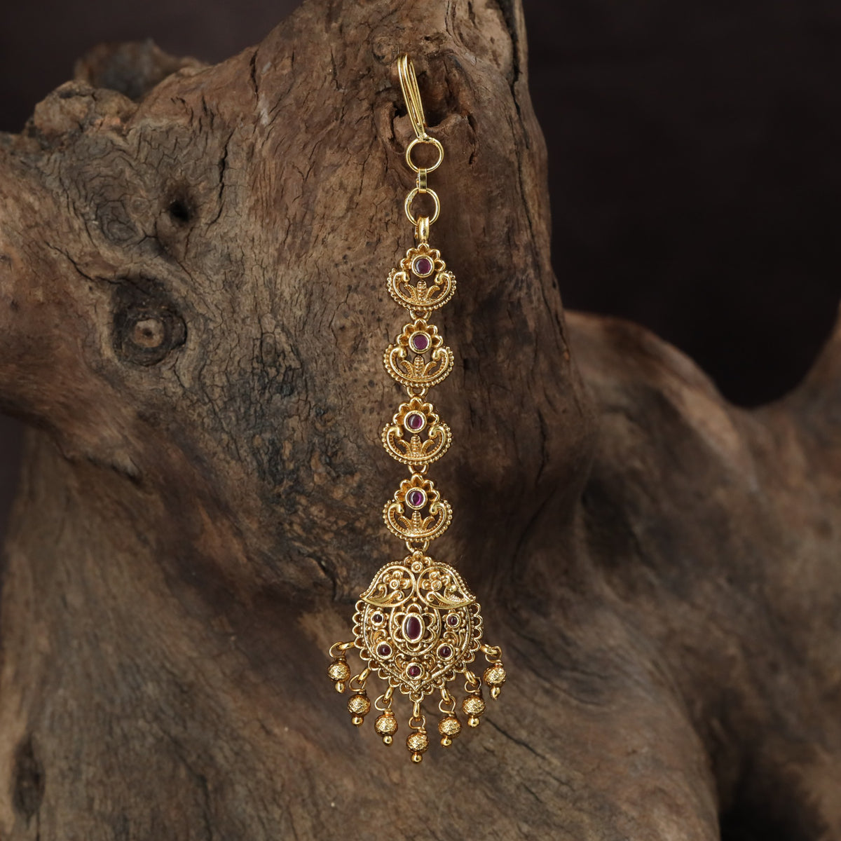 Occasion Wear Tikka with intricate floral detailing and an elaborate pendant arrangement