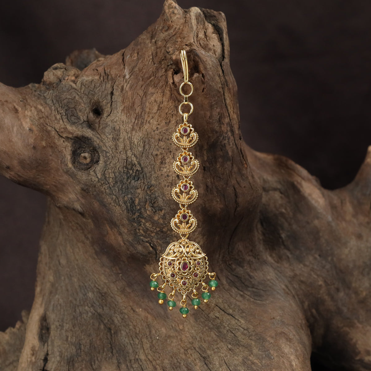 Occasion Wear Tikka with intricate floral detailing and an elaborate pendant arrangement