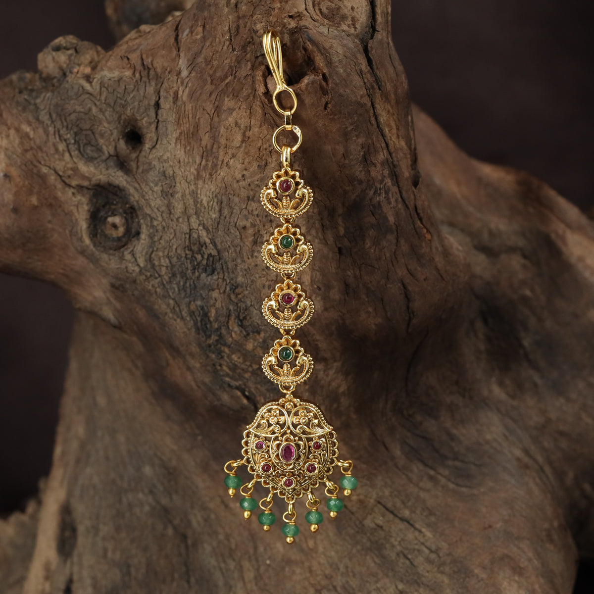 Occasion Wear Tikka with intricate floral detailing and an elaborate pendant arrangement