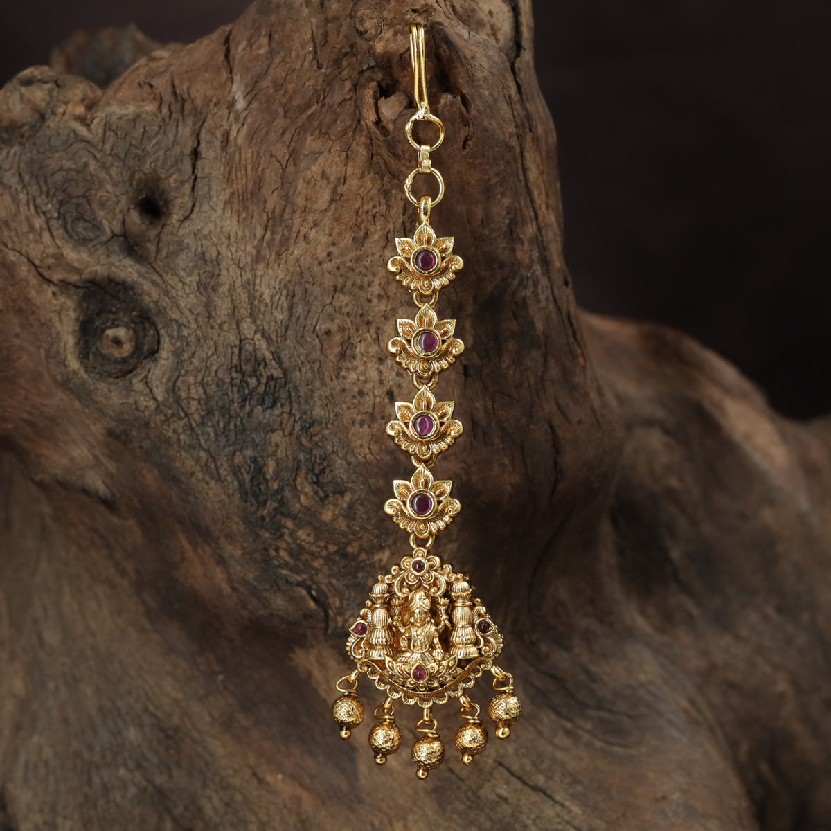Regal Lakshmi Tikka with floral links and an ornate deity pendant