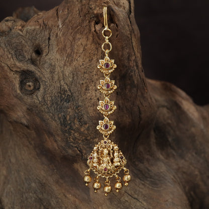 Regal Lakshmi Tikka with floral links and an ornate deity pendant