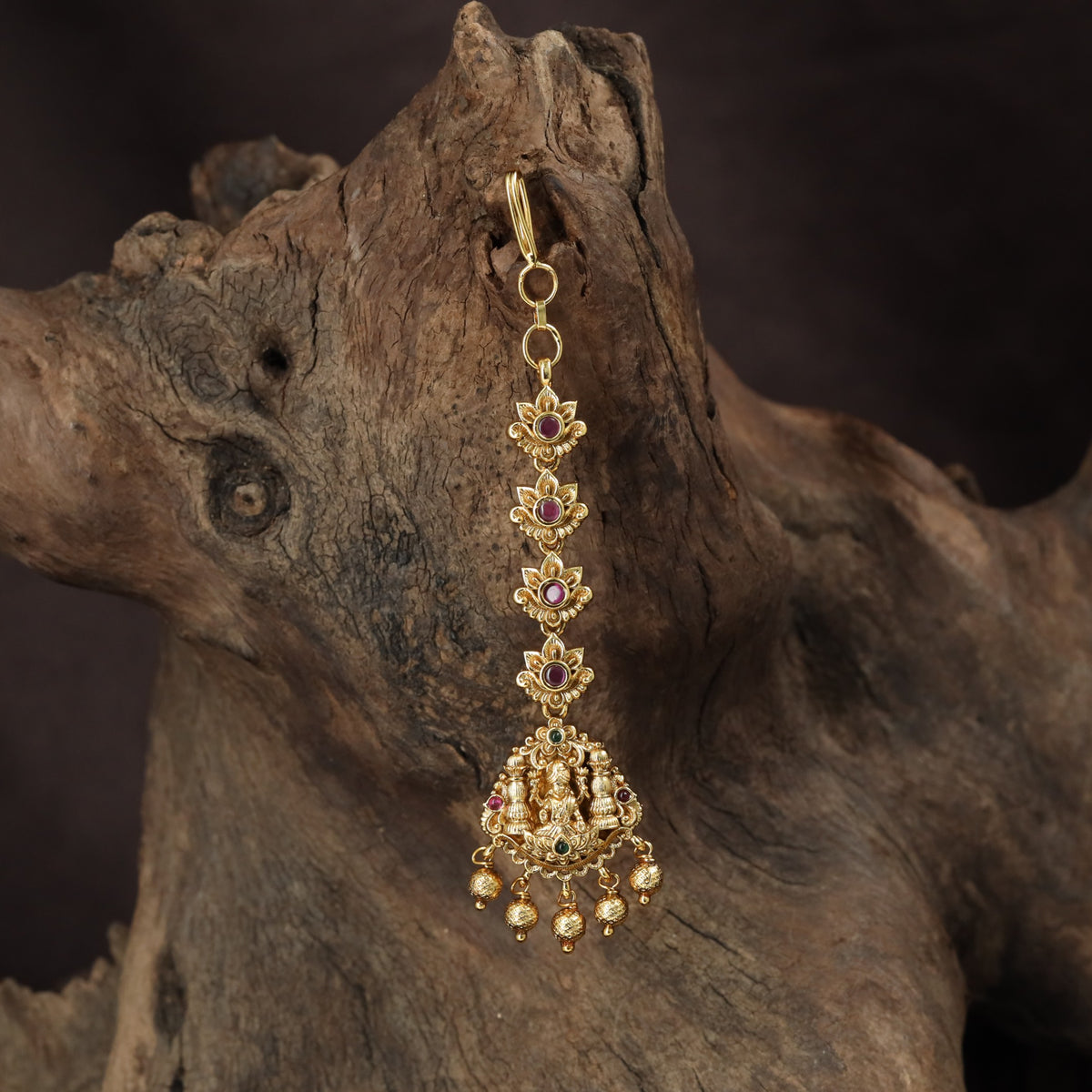 Regal Lakshmi Tikka with floral links and an ornate deity pendant