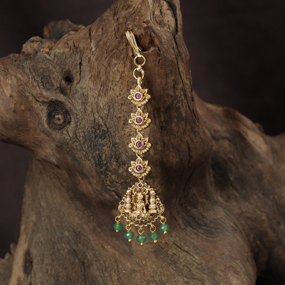 Regal Lakshmi Tikka with floral links and an ornate deity pendant