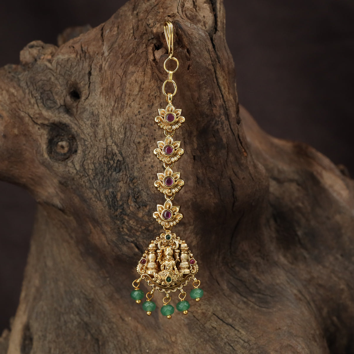 Regal Lakshmi Tikka with floral links and an ornate deity pendant