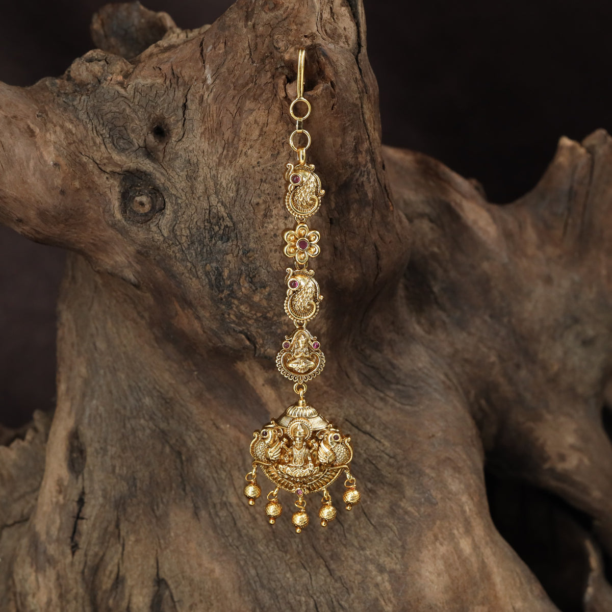 Signature Lakshmi Tikka with intricate circular elements and a richly detailed pendant