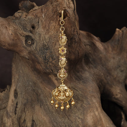 Signature Lakshmi Tikka with intricate circular elements and a richly detailed pendant